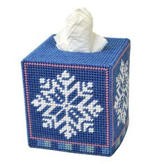 a tissue box with a snowflake design on it