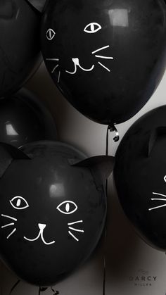 black balloons with white cat faces on them