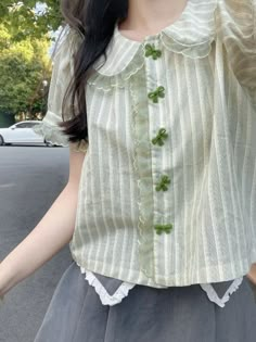 Be styled up and oh-so-adorable in this sweet Striped Harajuku Lace Bow Blouse! Featuring a cute Peter Pan collar, grass green stripes, velvet green bow buttons, and puff sleeves – this blouse is the perfect way to rock the Harajuku look in style. Look so very cute without breaking a sweat! 💚 Size Chart: Size Bust (cm) Shoulder (cm) Sleeve (cm) Length (cm) Bust (in) Shoulder (in) Sleeve (in) Length (in) S 118 31 21 43 46.46 12.20 8.27 16.93 M 122 32 22 45 48.03 12.60 8.66 17.72 L 126 33 23 47 4 Light Green Shirt Outfit, Cute Spring Outfits Aesthetic, Aesthetic Green Outfits, Green Top Outfit, Lace Shirts, Bodycon Dresses Casual, Harajuku Style, Cute Blouses, Bow Blouse