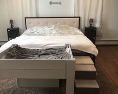 a bed sitting in the middle of a bedroom next to a window