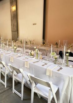 a long table is set up with white linens