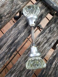 a glass door handle on an old wooden bench