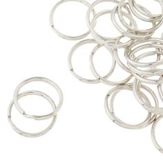 several silver colored rings on a white background