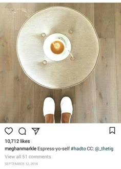 someone is sitting at a table with a cup of coffee