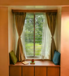 a window with curtains and pillows on it in front of a wooden dresser next to a window