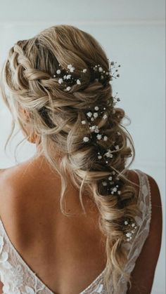 a woman wearing a wedding dress with flowers in her hair