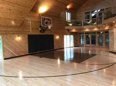 an indoor basketball court with wooden walls and flooring