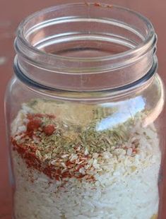 a glass jar filled with rice and spices