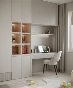 a white desk and chair in a small room with shelves on the wall behind it