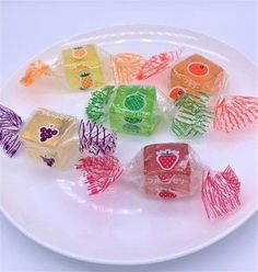 a white plate topped with assorted candy cubes on top of a white table