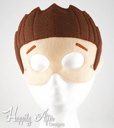 a white mannequin head with a brown mask on it