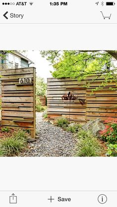 an image of a wooden fence in the middle of a yard with flowers and trees