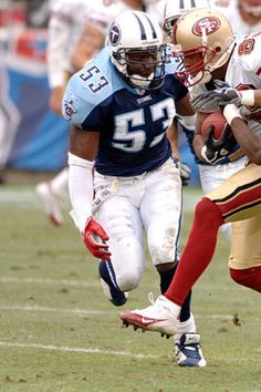 two football players are running on the field