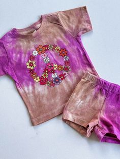 Discover the perfect ensemble for your little fashionista with our trendy toddler girl outfit sets on Etsy! Our matching sets for babies and toddlers are the epitome of style and comfort, featuring adorable two-piece combinations that are sure to make your child stand out. Dive into our collection of trendy girly outfits, including the must-have floral peace sign shirt for girls, paired with chic biker shorts. Each set showcases a unique violet and beige tie-dye design, adding a splash of color Cotton Playwear Sets With Graphic Print, Cotton Graphic Print Playwear Sets, Cotton Graphic Print Sets For Playwear, Cute Short Sleeve Purple Set, Multicolor Playwear Sets For Spring, Matching Spring Playwear Sets, Playful Matching Sets For Spring, Playful Spring Matching Sets, Trendy Cotton Short Sleeve Sets