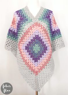 a crocheted granny shawl on a mannequin