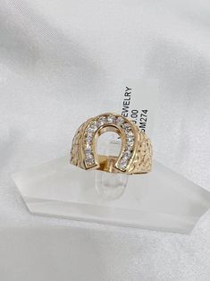 -14k horseshoe nugget design ring  -100%  gold  -good for daily use  -ring size  10  -ring can be resize  -nugget finish on sides  -stones are white cubic zirconias -item sold by piece. weigth is undetermined Elegant Gold Horseshoe Rings, Gold Horseshoe Diamond Jewelry, Luxury Horseshoe-shaped Yellow Gold Jewelry, Vintage Gold Horseshoe Jewelry, Gold Nugget Ring, 14-karat Yellow Gold Horseshoe Jewelry, Horseshoe Ring, Gold Nugget, Size 10 Rings