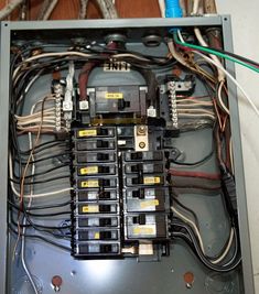 an electrical panel with multiple wires in it