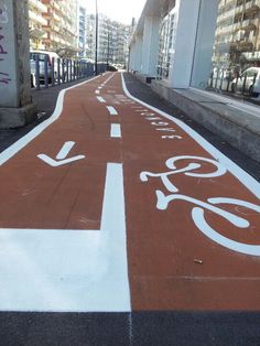 a bike lane painted with white and red paint