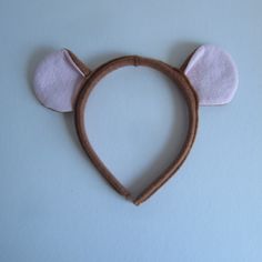 a felt mouse ears headband is shown on a white surface with light blue background