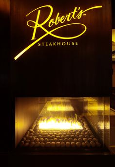 the sign for robert's steakhouse is lit up