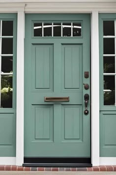 a green front door with white trim and windows