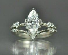 an engagement ring with a pear shaped diamond