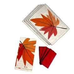 three napkins with red and orange leaves on them