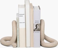 three books are stacked on top of each other in the shape of an animal's legs