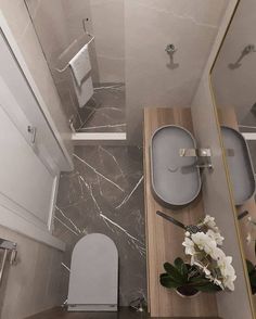 a bathroom with a toilet, sink and shower in it's stall area is shown from above