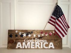 a wooden sign with an american flag hanging from it