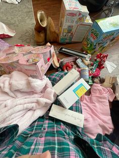 a pile of clothes and other items on the floor next to a box with toothbrushes