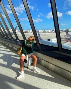 a woman sitting on the edge of an airport