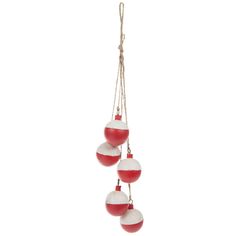 three red and white ornaments hanging from strings