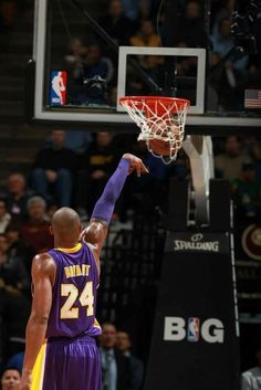 the basketball player is getting ready to dunk the ball in front of the crowd