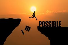 a man jumping off the edge of a cliff into the sky with words impossible written on it