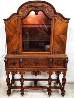 an old wooden dresser with a mirror on top