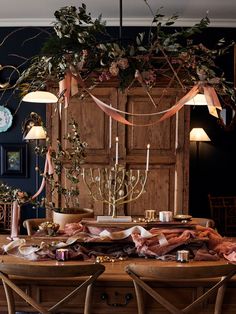 a dining room table with candles and flowers on it