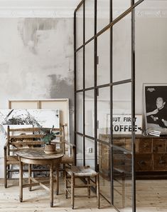 an old fashioned dining table and chairs in a room with peeling paint on the walls