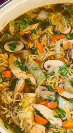 a large pot filled with noodles and vegetables