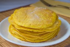 a stack of pancakes sitting on top of a white plate