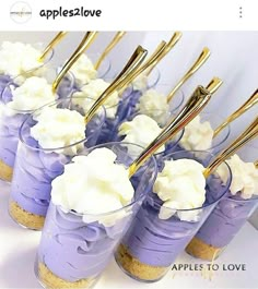 there are many desserts in small cups with gold forks sticking out of the top