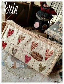 a purse with hearts on it sitting on top of a table next to other items