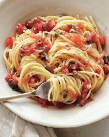 a white bowl filled with pasta and tomatoes