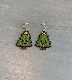 a pair of pixelated christmas tree earrings