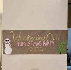 a sign that says weekend's club christmas party with a snowman on it