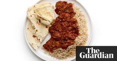 a white plate topped with rice and meat next to tortilla shells on top of it