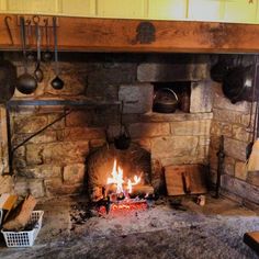 an old fireplace with pots and pans on it