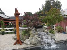 a water fountain in the middle of a garden