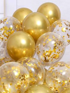 gold and white balloons with confetti on them are ready to be thrown into the air