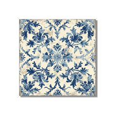 a blue and white tile with an ornate design